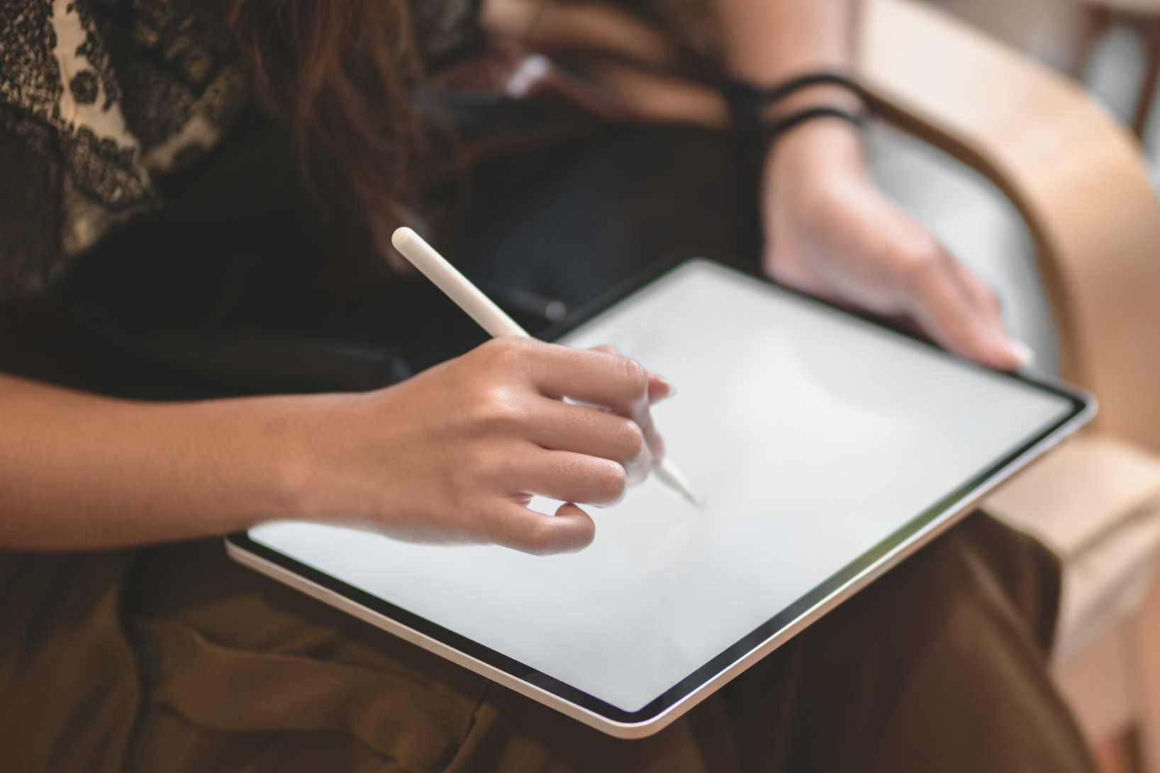 Person working on tablet with magic pencil, representing clinical trial design and startup in TrialKit