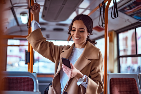 Woman using public transit and using her own smartphone to participate in clinical trial while on-the-go